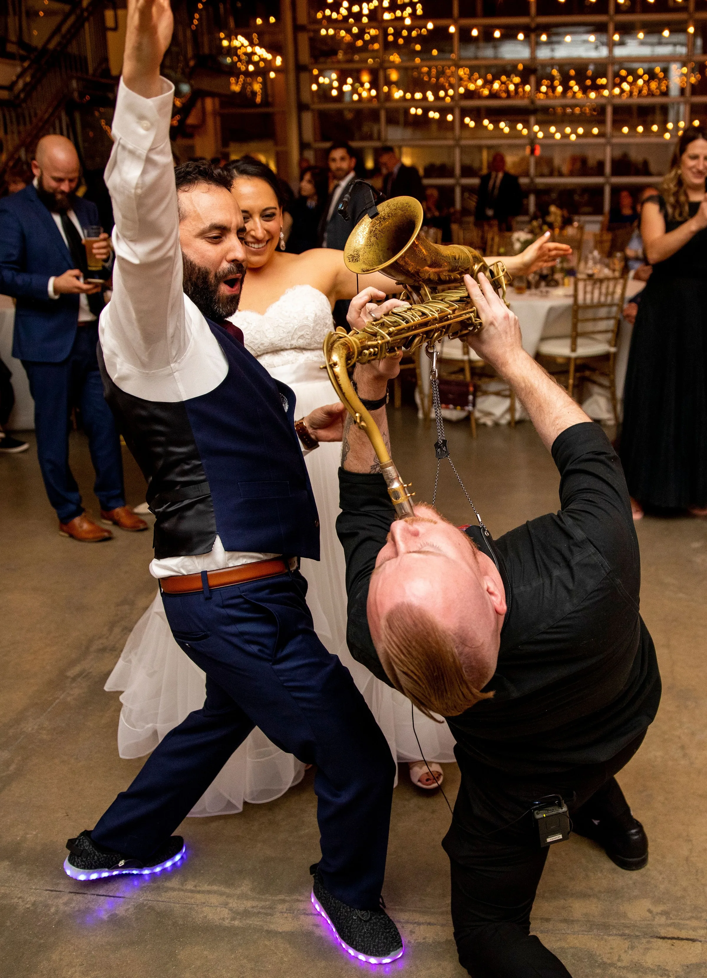 Soul City Band saxophonist performs dramatic floor move for bride and groom at an energetic wedding reception in Newport RI