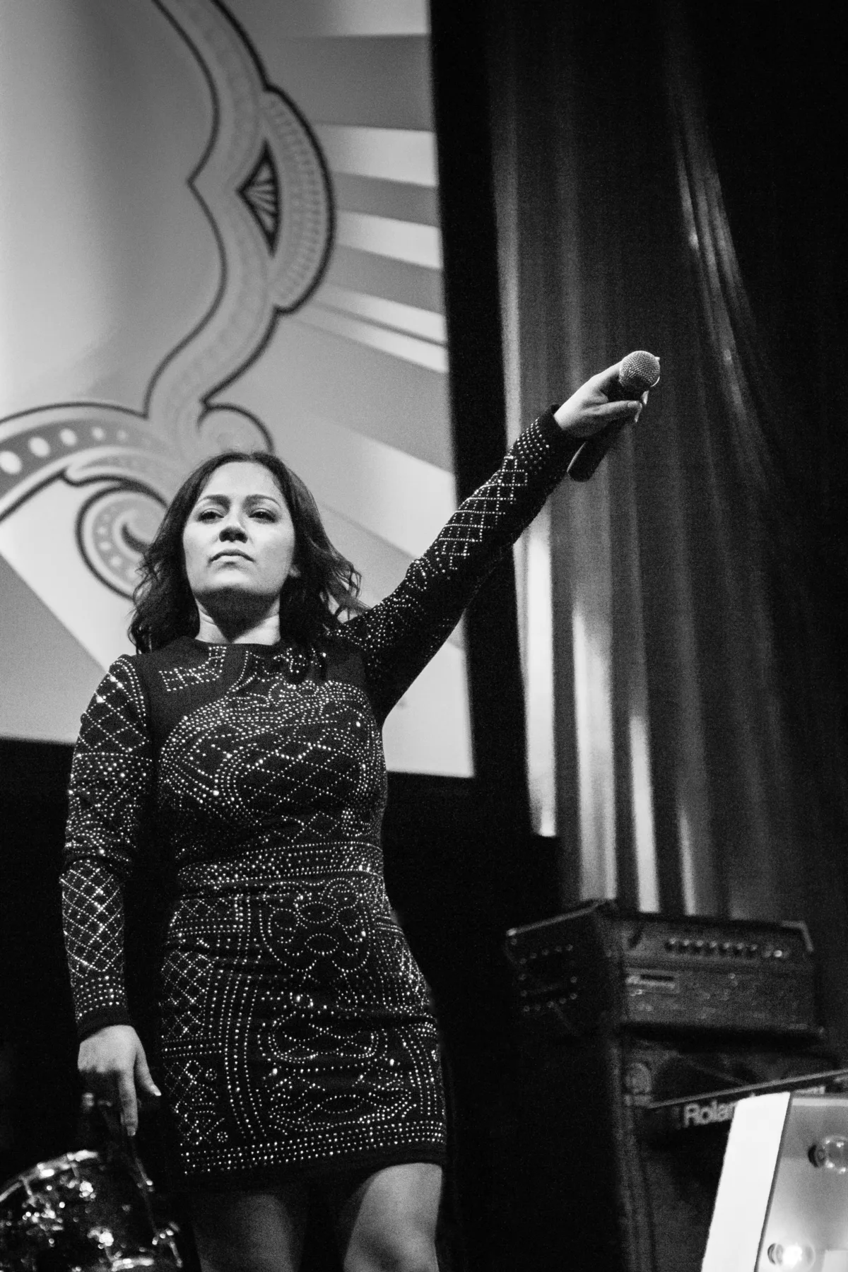 Female vocalist performing on stage holding microphone overhead with Soul City Band, a live wedding and event band serving Newport RI and Boston MA