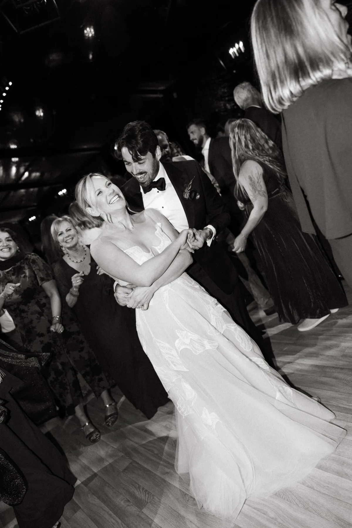 Bride and groom sharing a joyful first dance surrounded by guests at a wedding reception in Newport RI with live band entertainment by Soul City Band