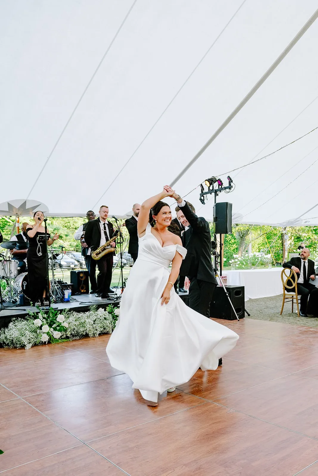 Bride twirling during first dance to Soul City Band live performance at an elegant tented wedding reception in Newport RI