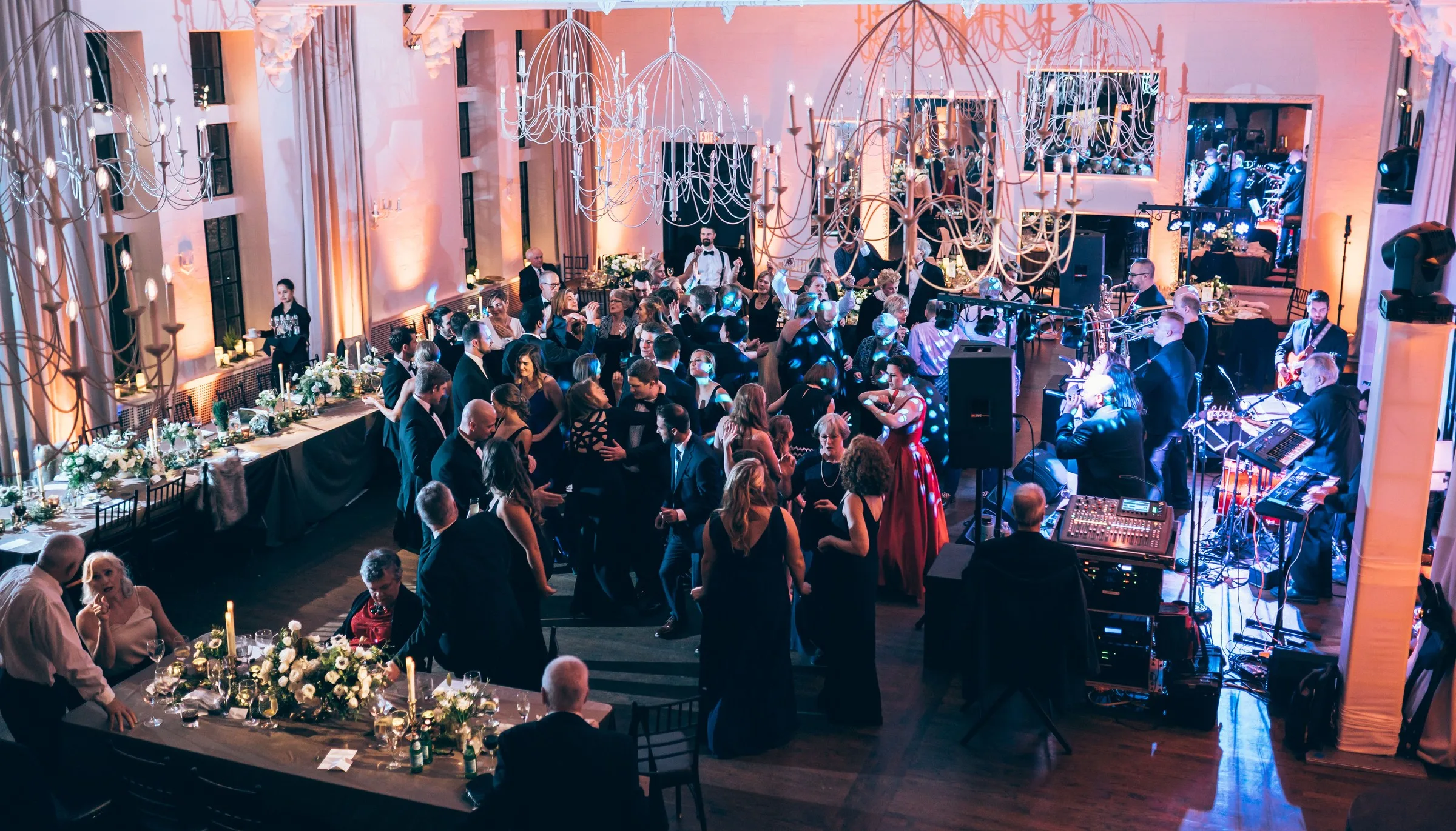 Soul City Band performing live for a packed wedding reception dance floor at an elegant ballroom venue in Newport, Rhode Island, with guests dancing in formal attire beneath ornate chandeliers
