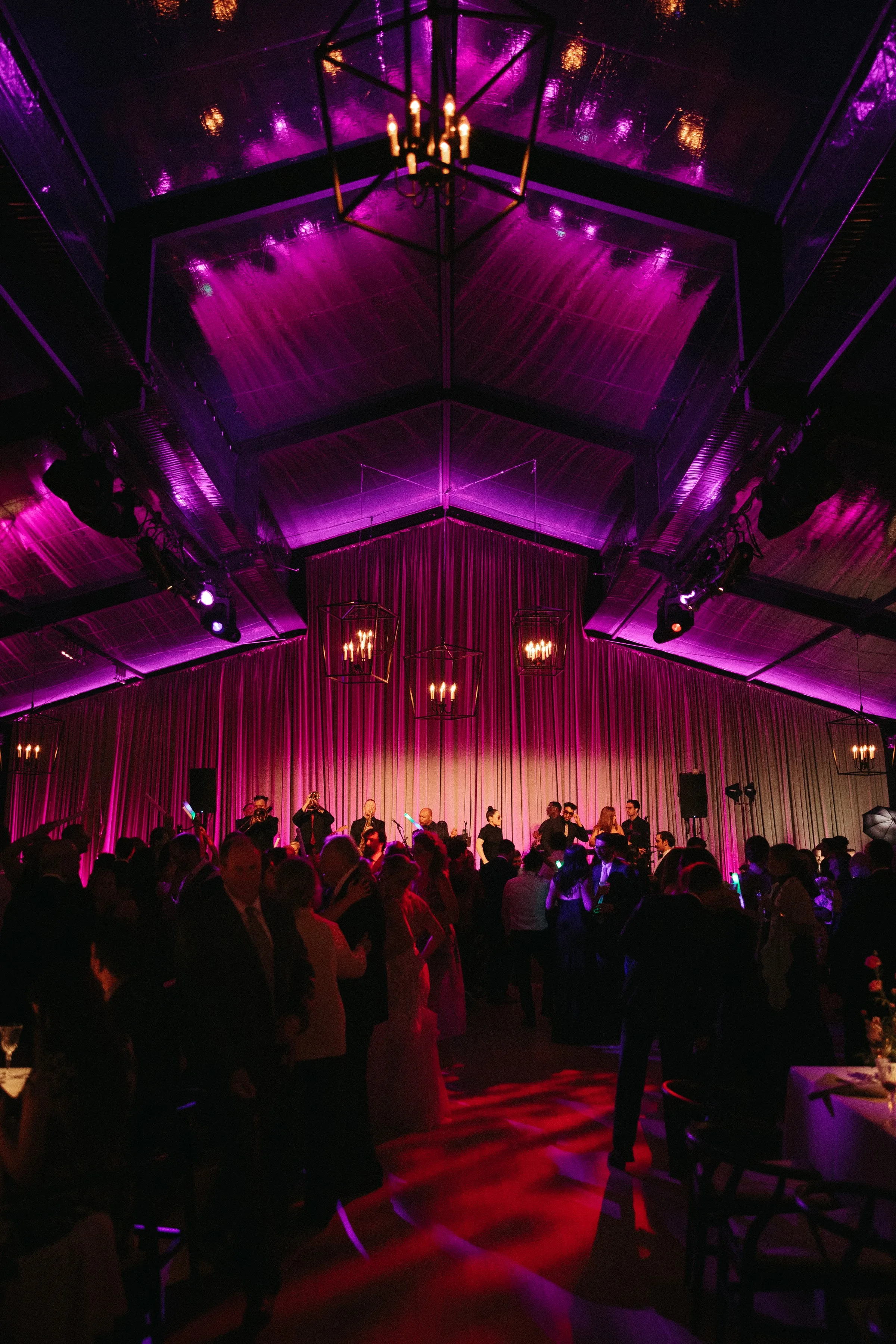 Soul City Band performing live for a crowded wedding reception dance floor under dramatic purple uplighting in Newport Rhode Island