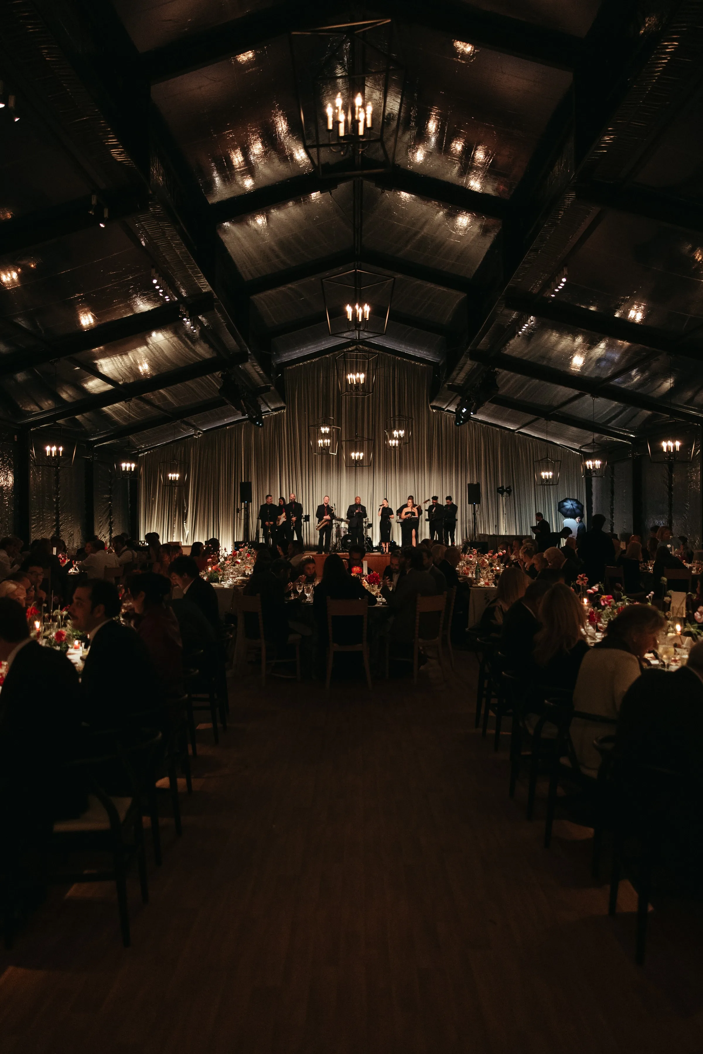 Soul City Band performing live on stage during an elegant candlelit wedding reception in a tented venue in Newport RI