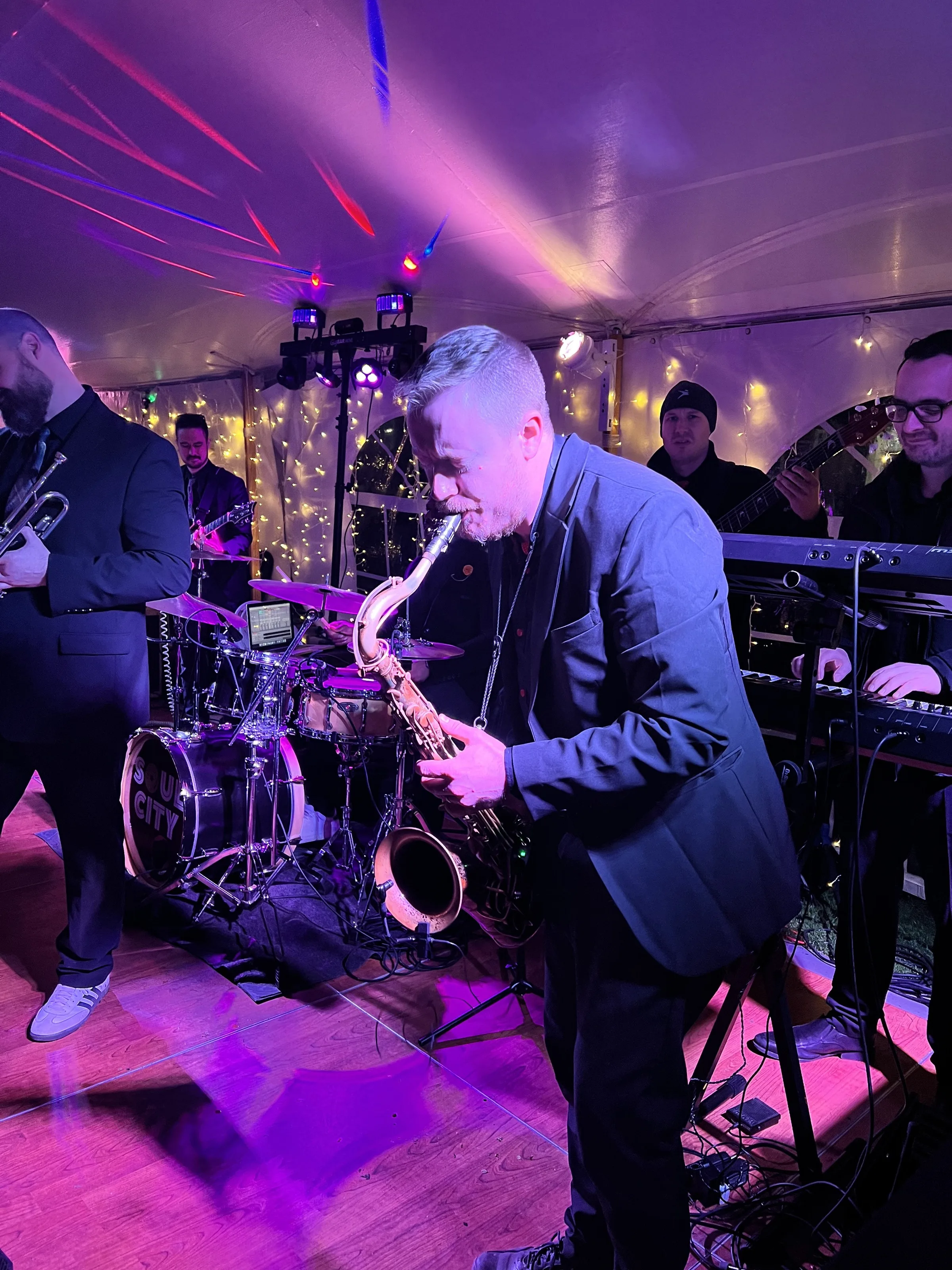 Soul City Band saxophonist performs live at an elegant tented wedding reception with full band including drums, guitar, and keyboards, Newport RI