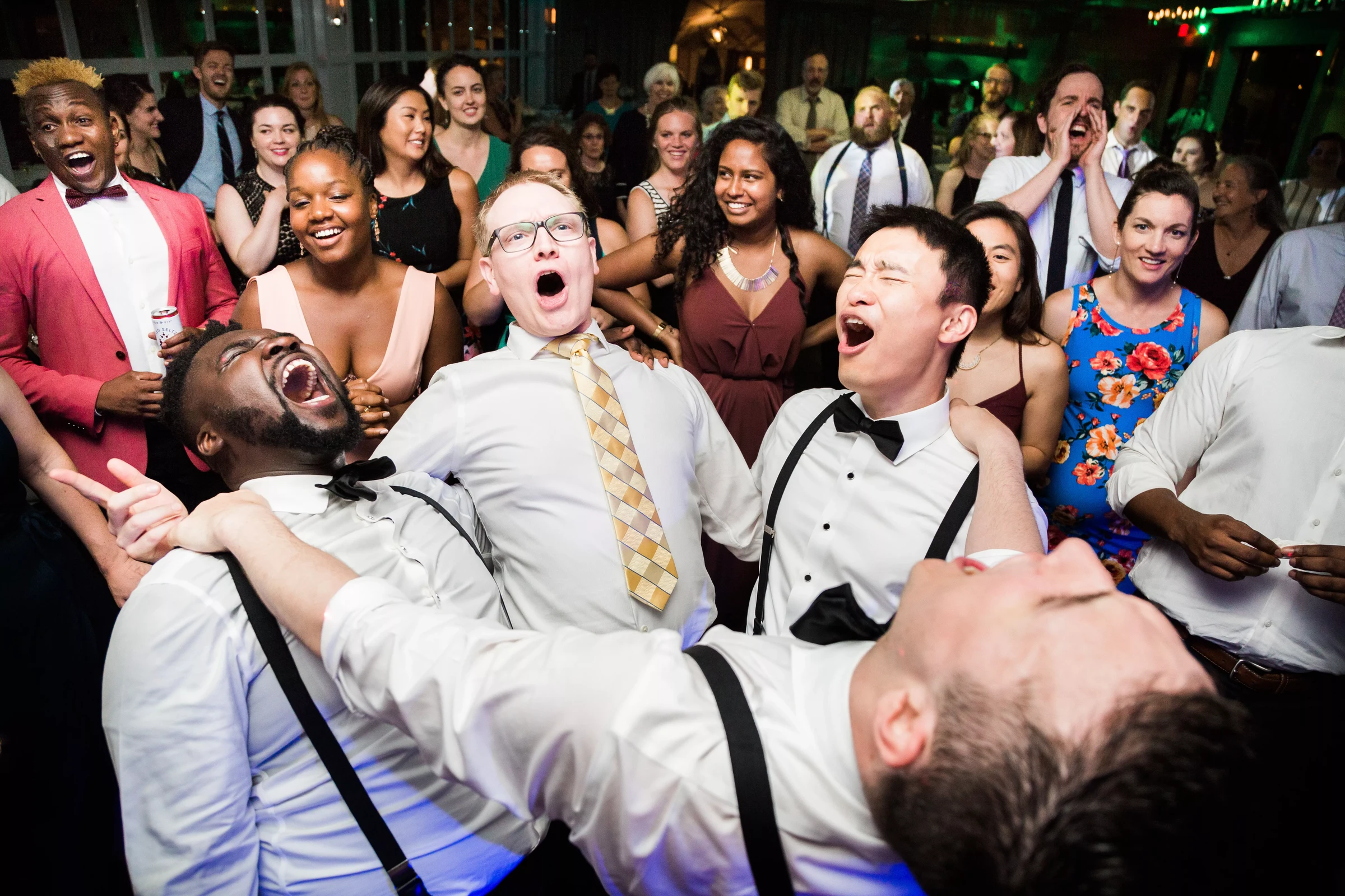 Excited wedding guests singing and dancing at a high-energy reception party with Soul City Band performing in Newport RI