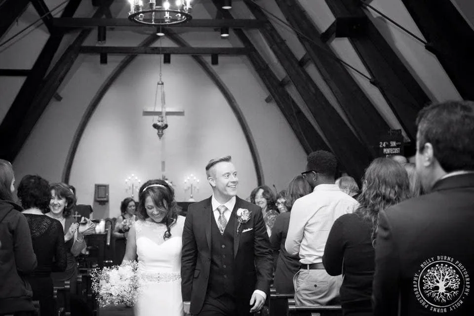 Bride and groom walking down the aisle during wedding recessional at a church ceremony in Newport RI with live wedding entertainment by Soul City Band